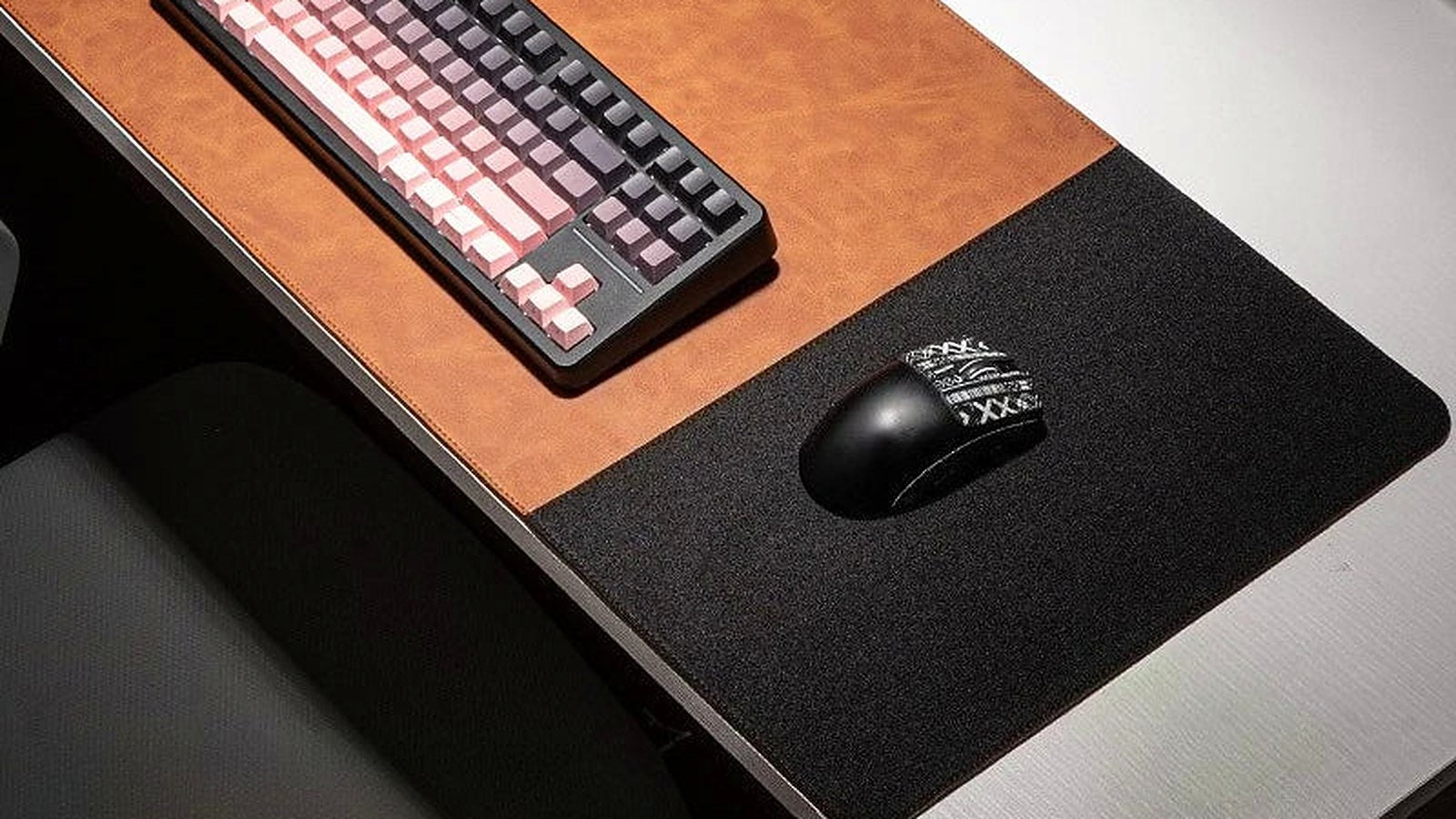 A leather and cork desk mat with a mechanical keyboard and mouse